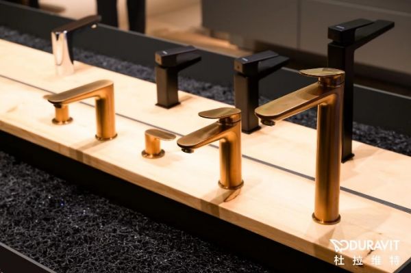 A row of faucets on a counter Description automatically generated